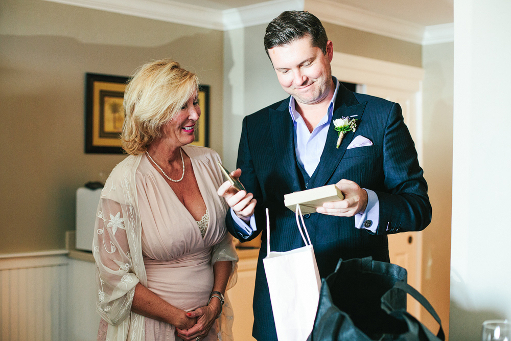 This is a photo of Rocco opening his gift from Helen on their wedding day.