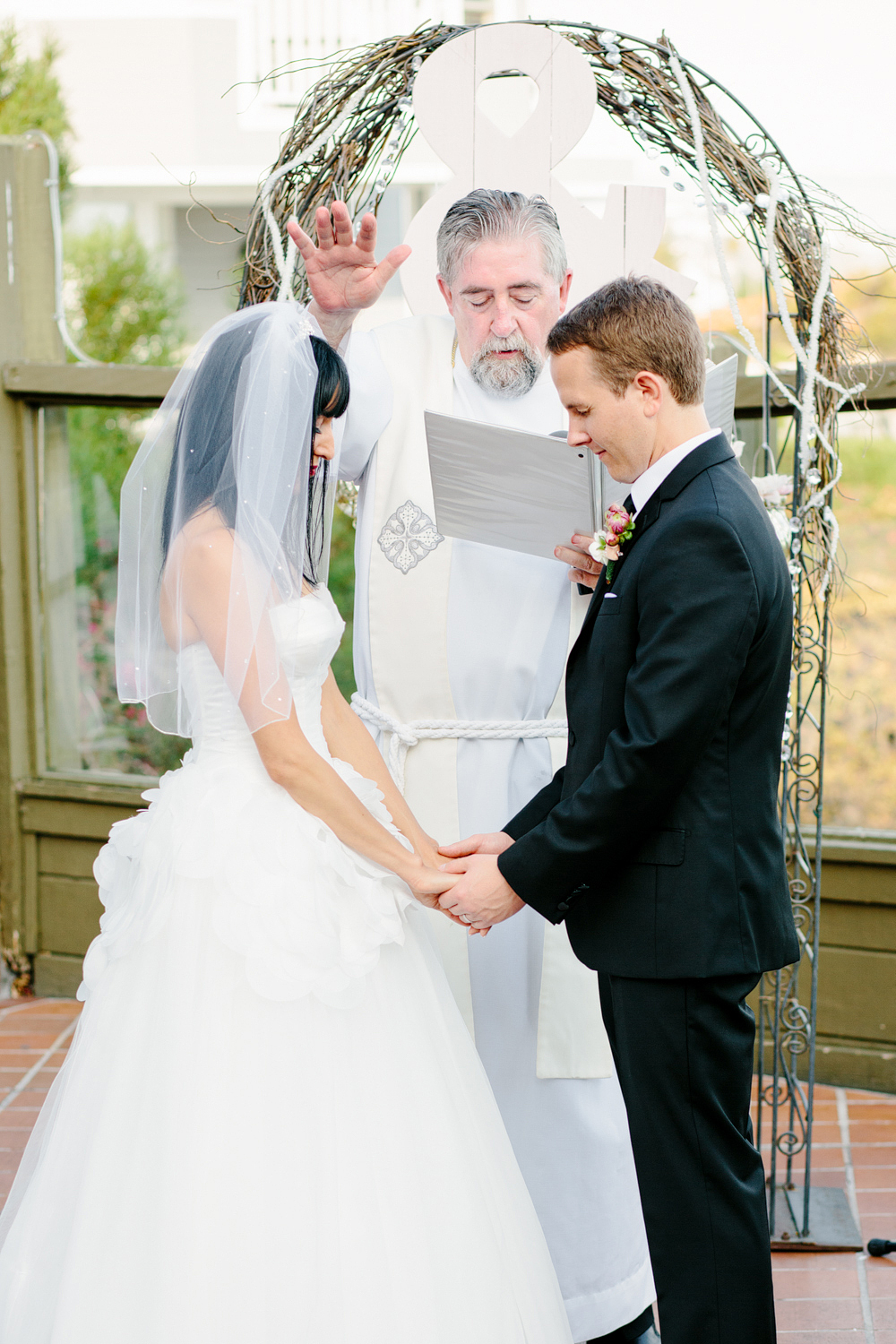 This is a cool photo of the preacher praying over Parisa and Michael.