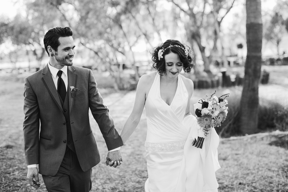 The bride and groom are walking back to their reception.