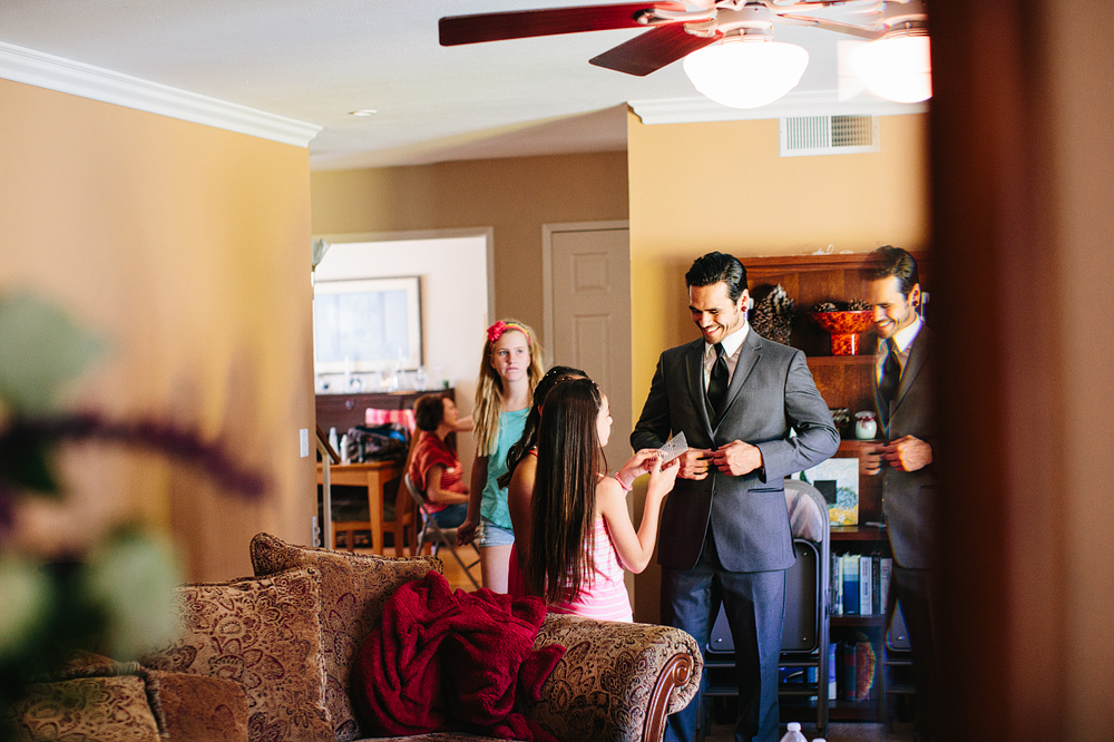 This is a nice candid moment while the groom is getting ready.