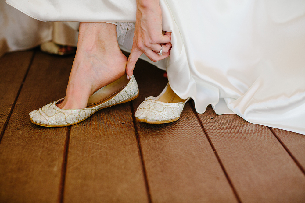 This is a photo of the bride putting on her shoes.