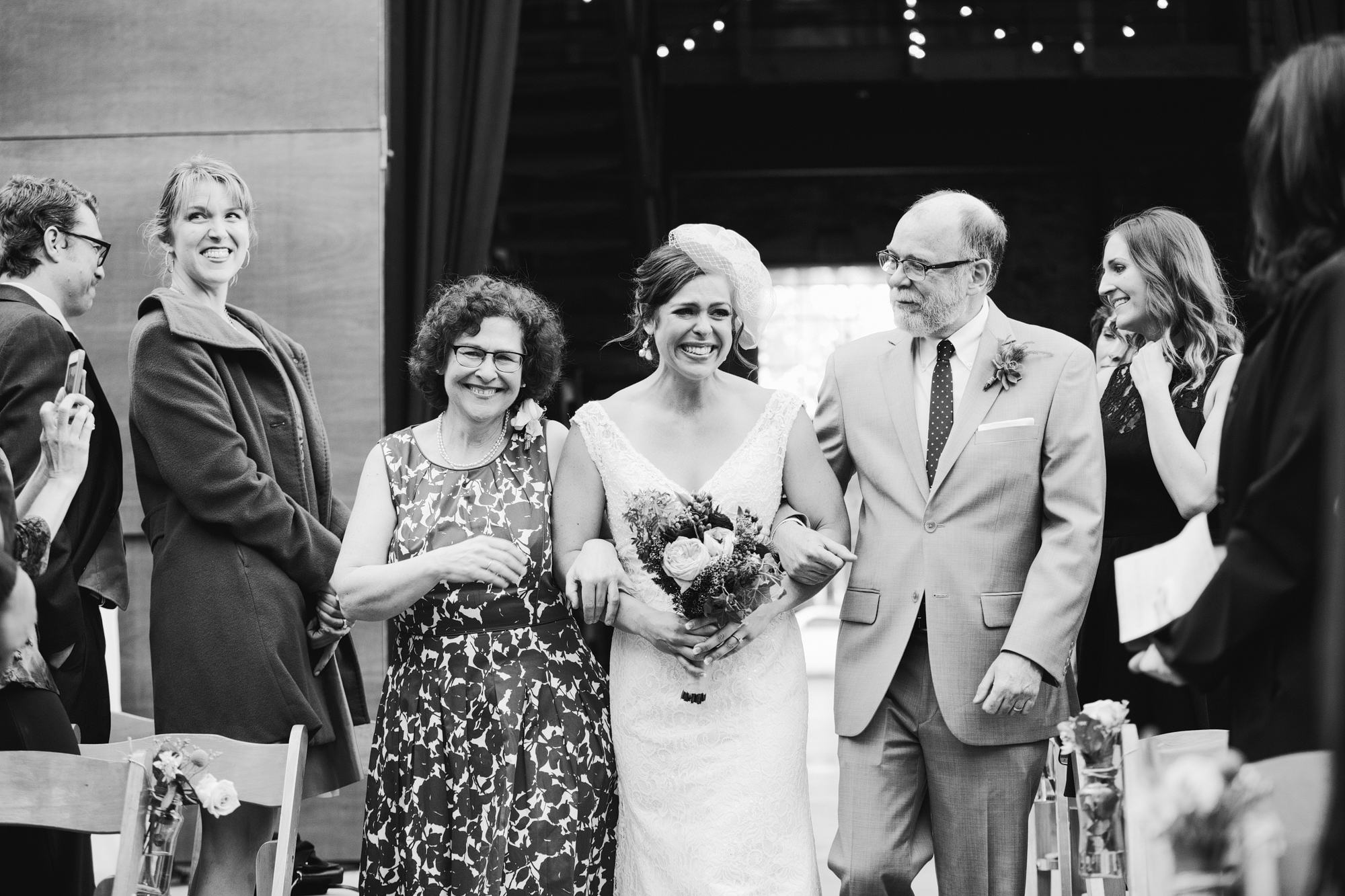 This is a photo of Rachel walking down the aisle with her parents. What a precious moment!