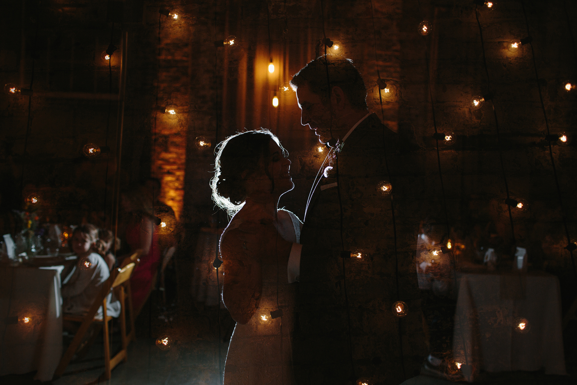 This is a killer double exposure of the market lights and Rachel and Seth's first dance.