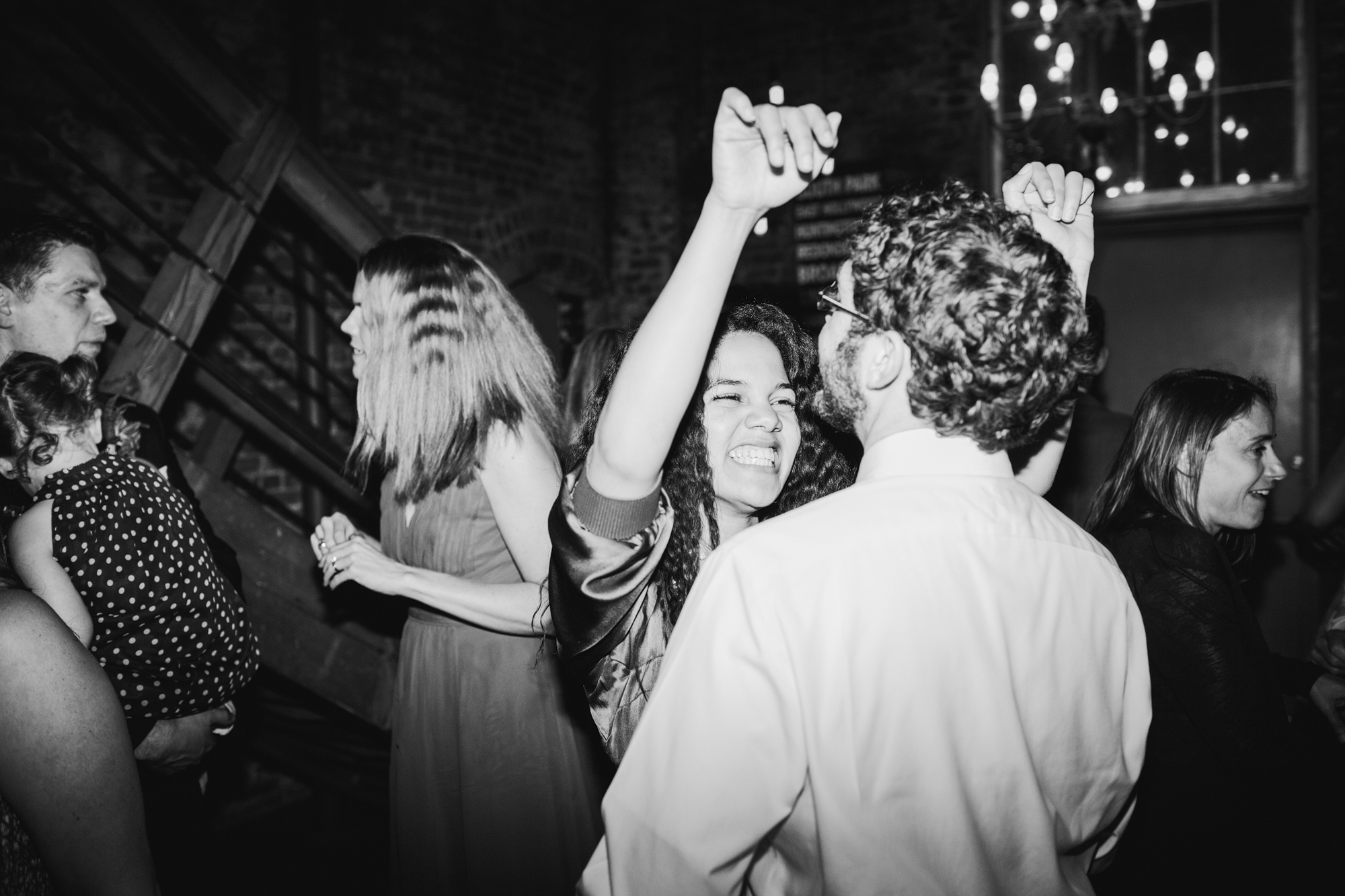 This is a photo of guests dancing at the wedding.