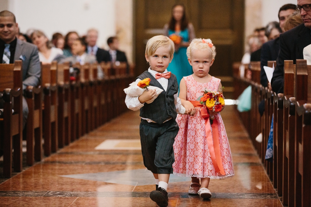 This is a photo of the ring bearer and the flower girl walking down the aisle.