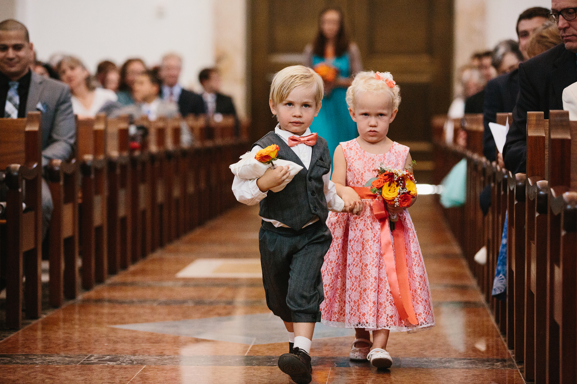 This is a photo of the ring bearer and the flower girl walking down the aisle.