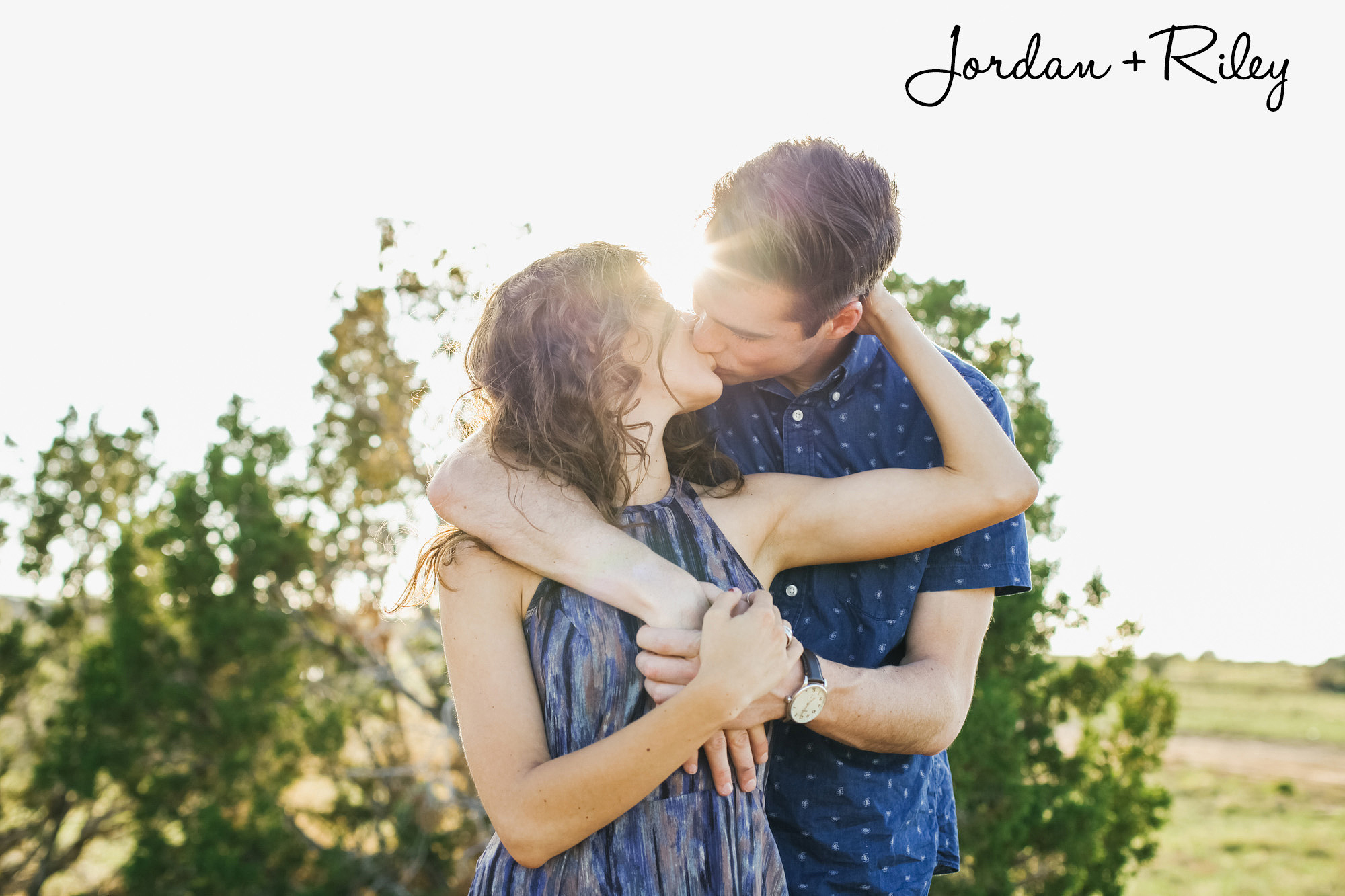 Jordan and Riley kissing at their engagement session in the desert. Santa Fe wedding photographer.