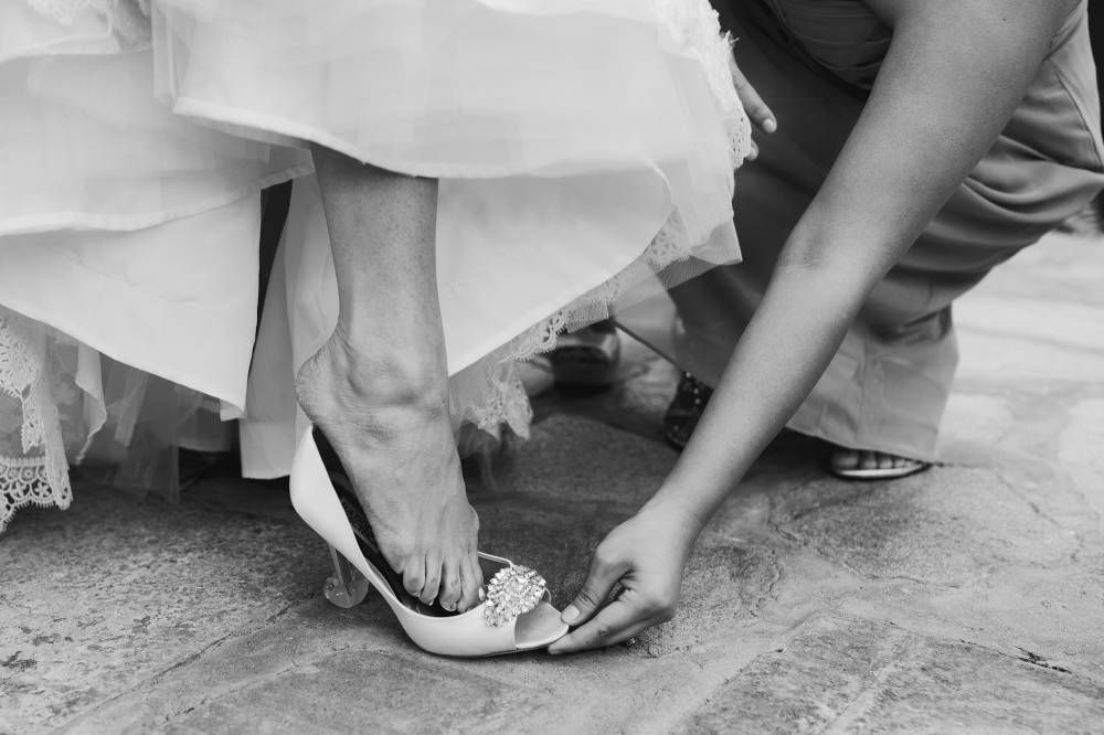 This is the bride putting on her shoe. 