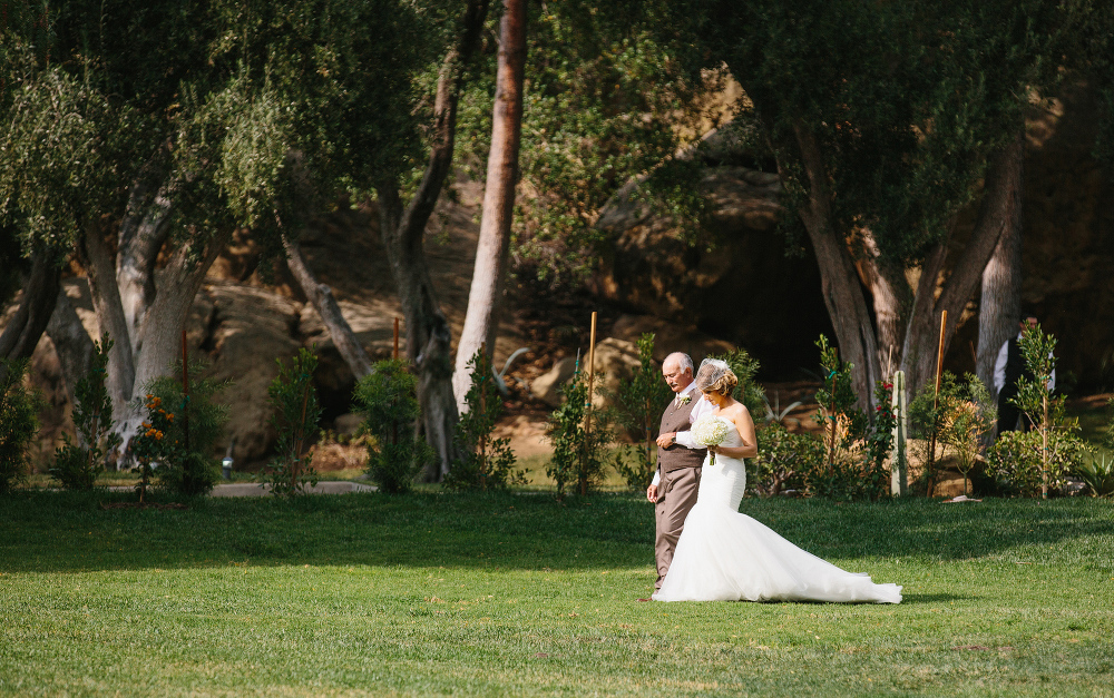 The bride and her dad walking down the aisle. 