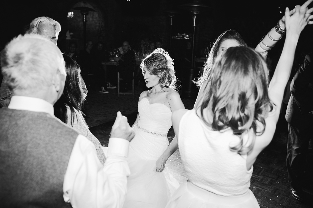 A black and white photo of the bride dancing during the reception. 