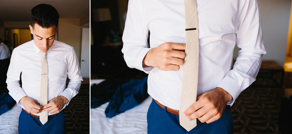 Here is a photo of the groom putting on his tie. 