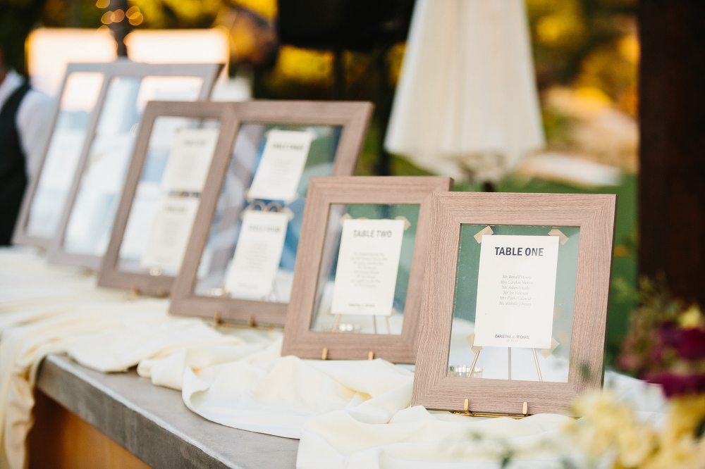 The seating chart was on cream paper in different sized wood frames. 