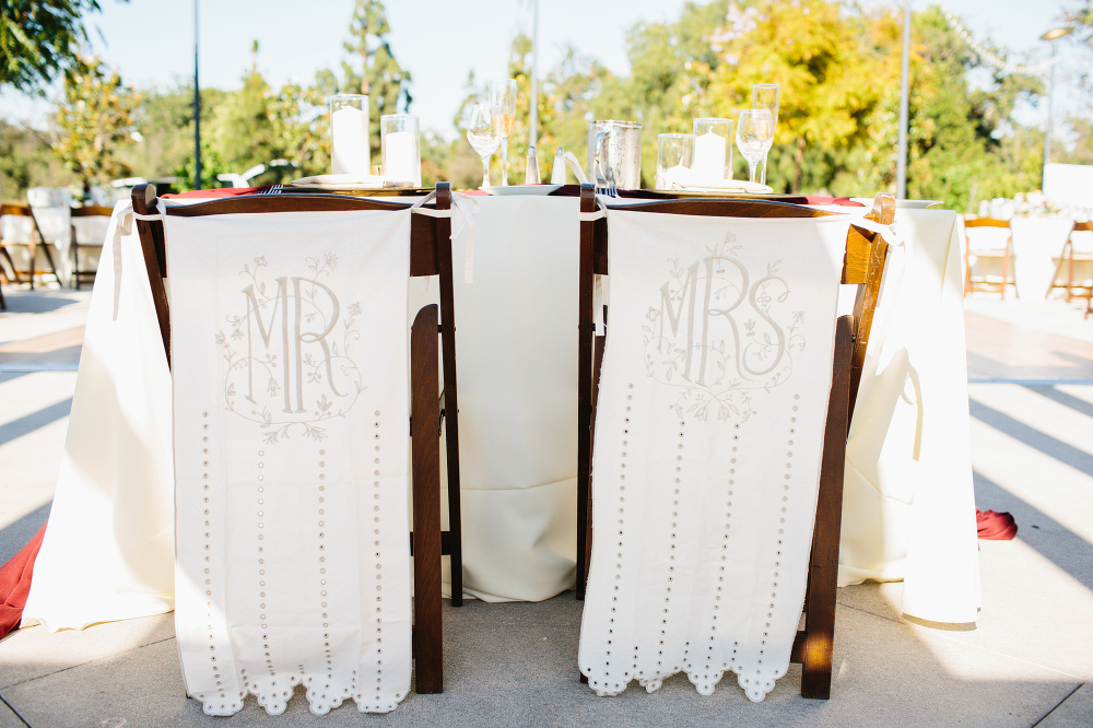 The bride and groom had Mr. and Mrs. signs behind their chairs. 