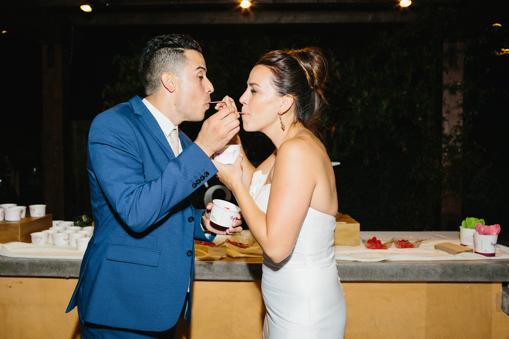 This is a photo of Christina and Mike sharing dessert at their wedding. 