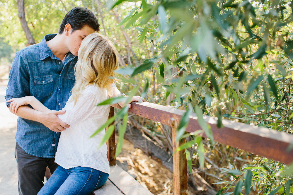 Here is a photo of Lauren and Alex kissing on a bridge. 