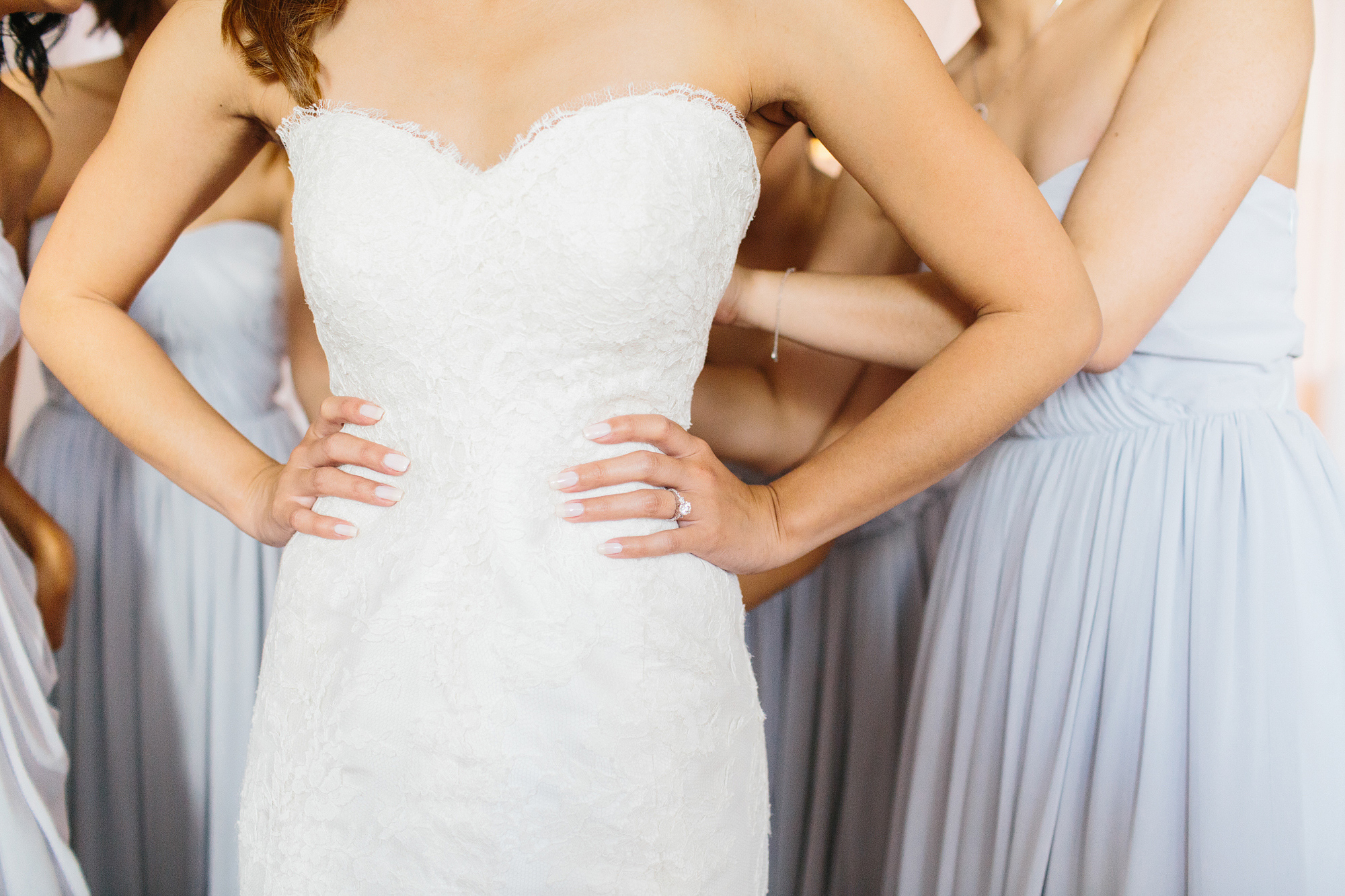 Here is a photo of the bride putting on her wedding dress. 