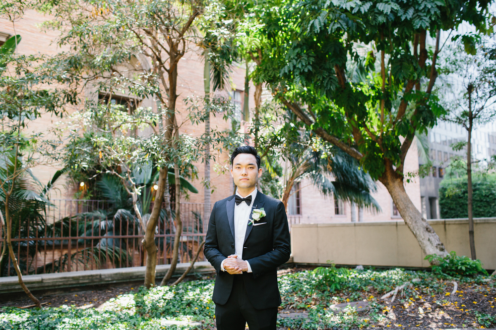 The groom wore a black bow tie. 