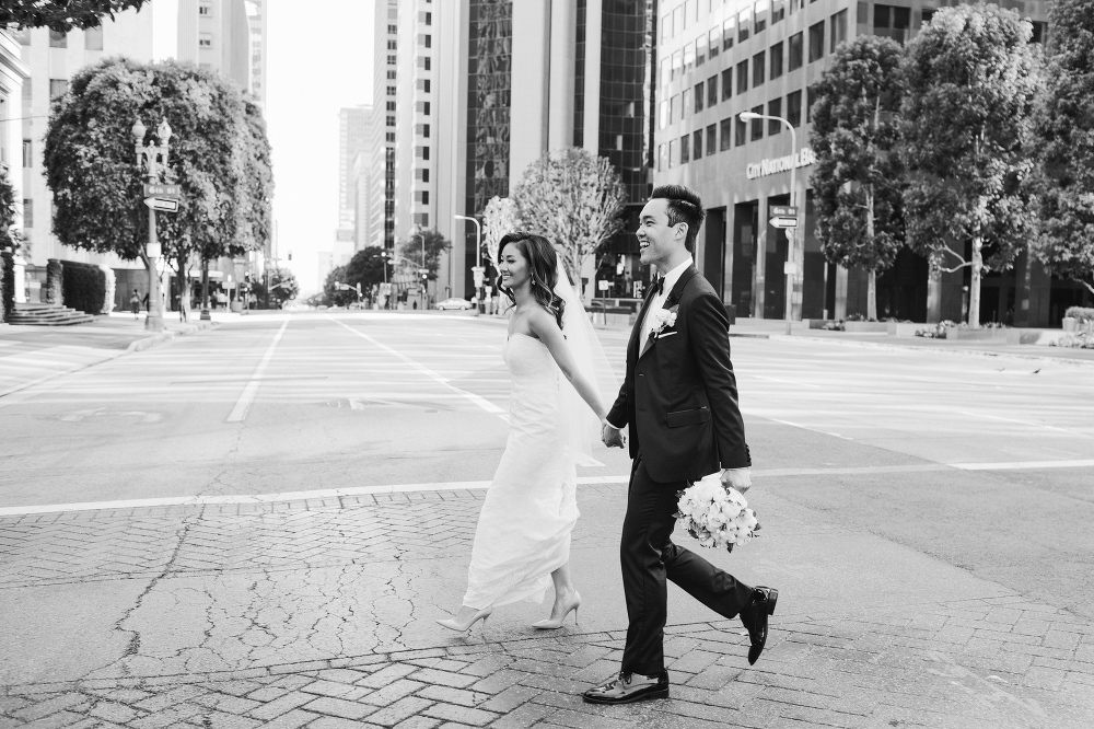 A black and white photo of the bride and groom walking in Los Angeles. 
