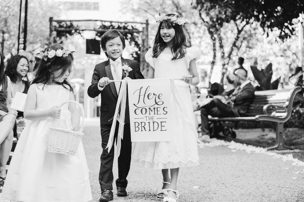 The flower girl and ring bearer carried a cute sign. 