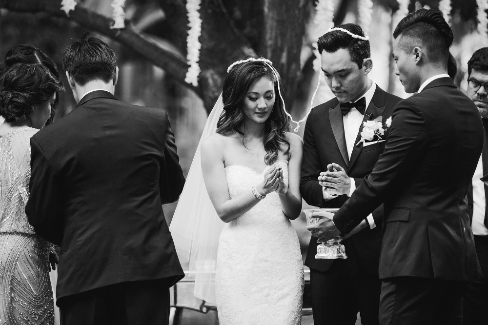 The bride and groom having their hands washed during the Thai ceremony. 