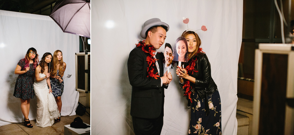 A photo of the bride using the photo booth with wedding guests. 
