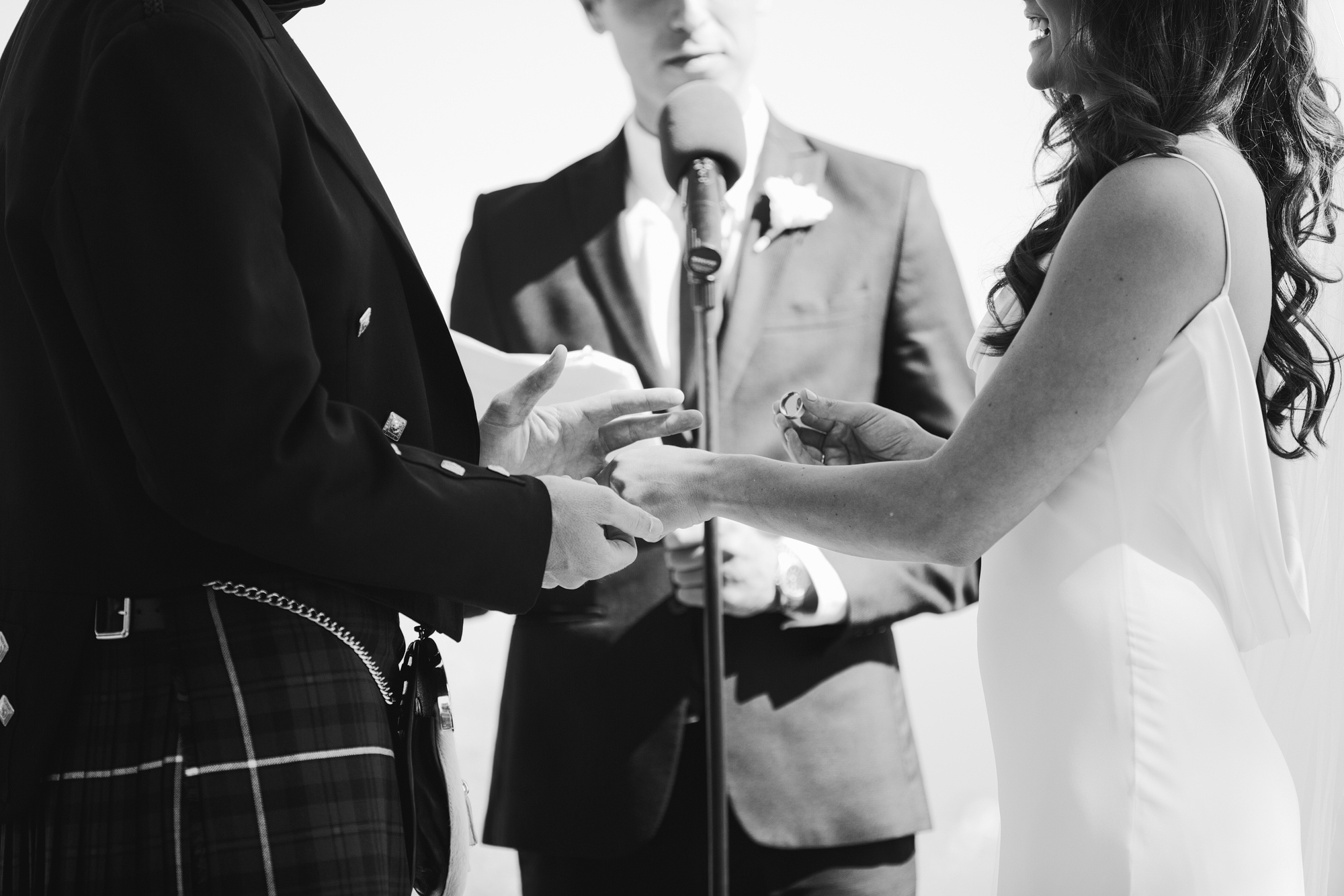 The bride putting the ring on the groom