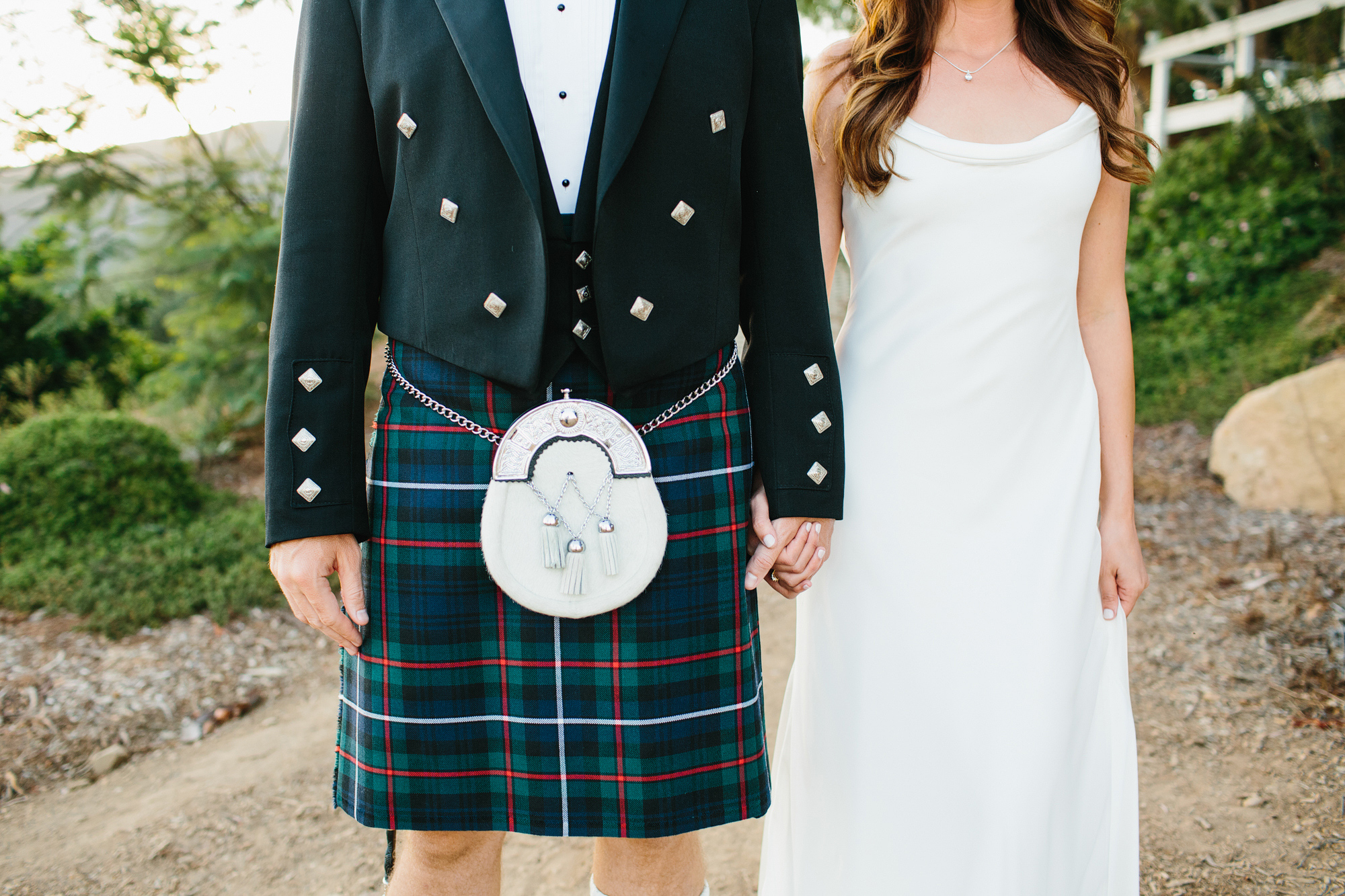 A photo of the bride's dress and groom's kilt. 
