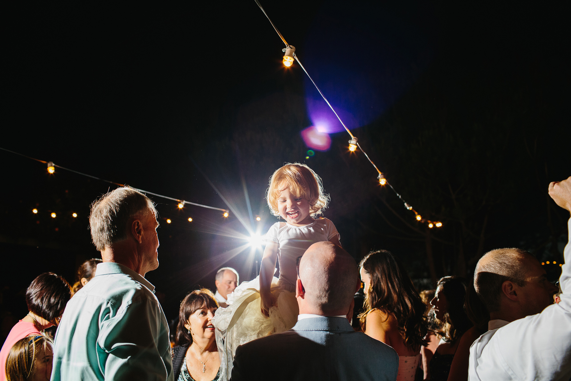 An adorable flower girl dancing. 