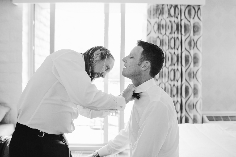 The Best Man helping the groom get ready. 