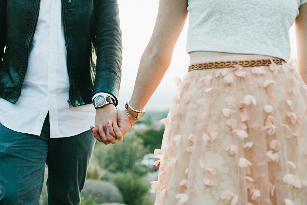 Jacqueline and Chris holding hands. 