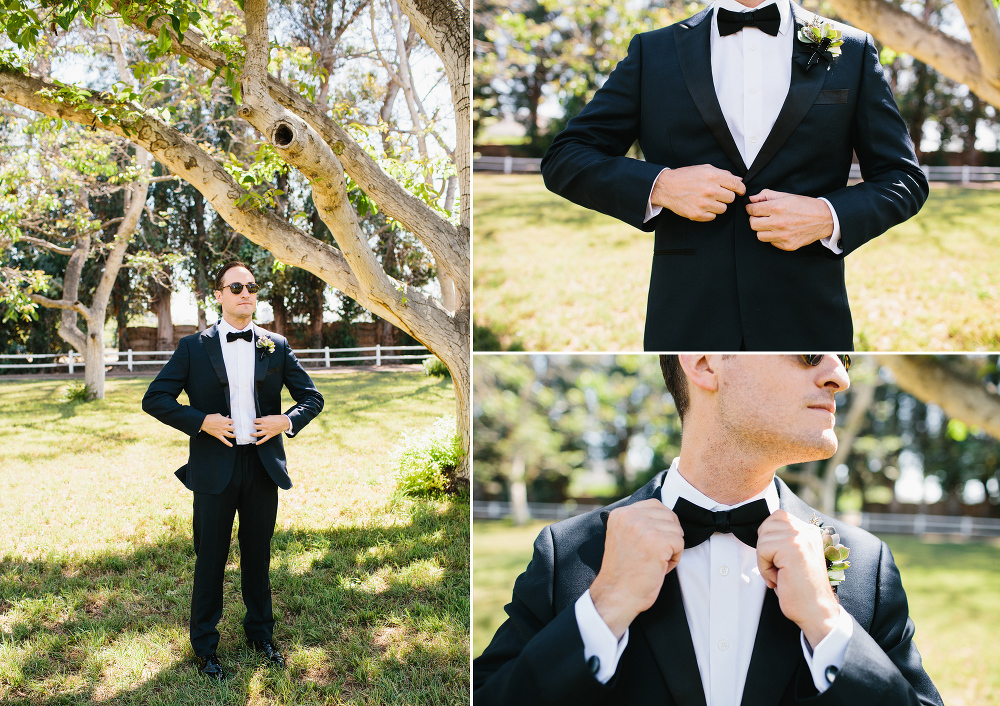 The groom wore a black tuxedo and black bow tie. 