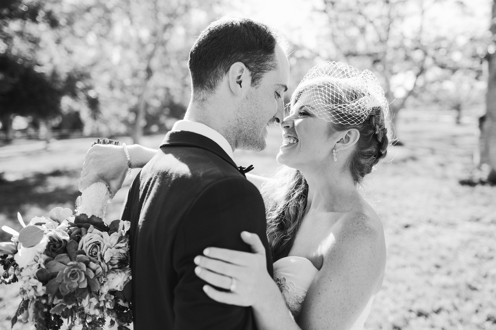 An adorable photo of the bride and groom touching noses. 