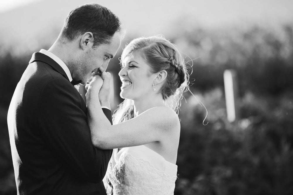 A cute photo of the bride and groom holding hands. 