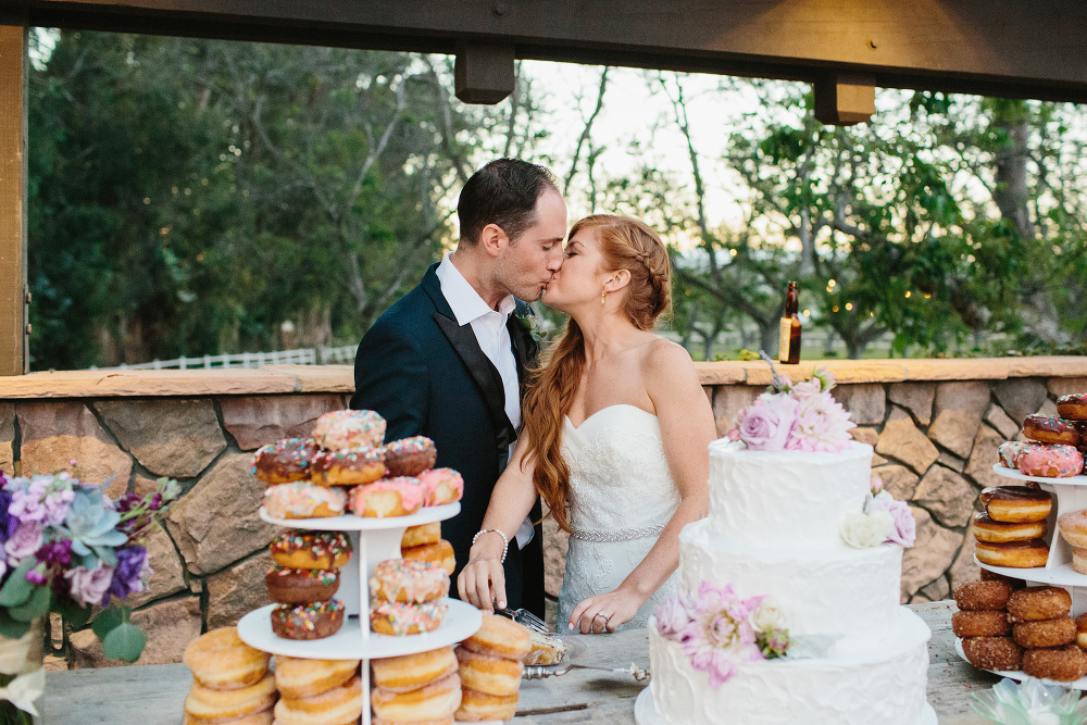 Carrie and Justin kissing after cutting the cake. 