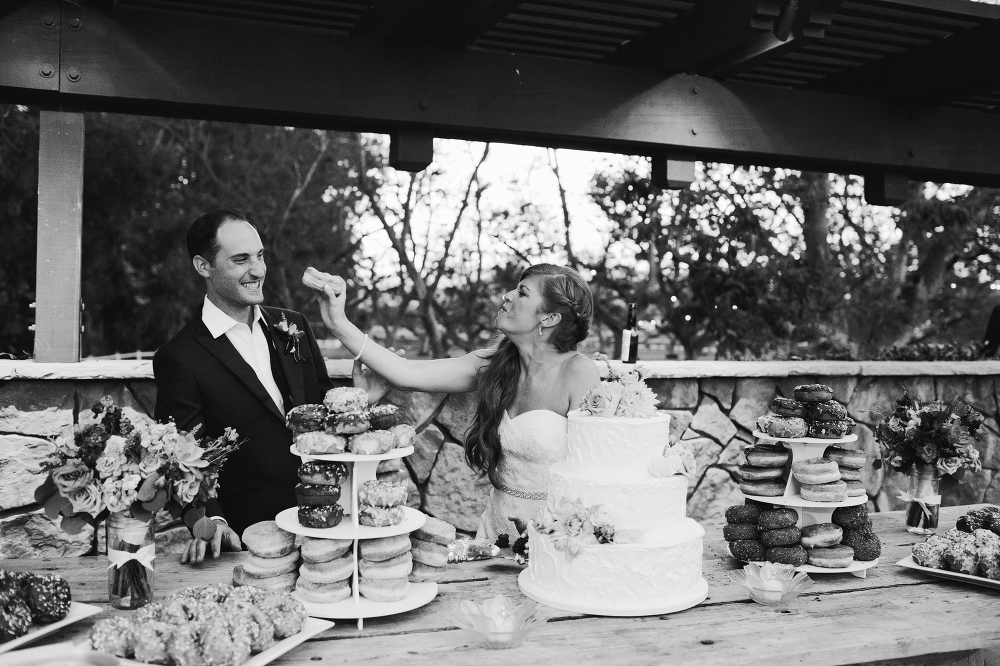 Carrie giving Justin a bite of a donut. 