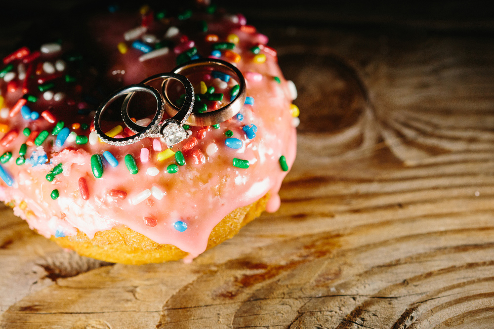 The wedding rings on a sprinkle donut. 