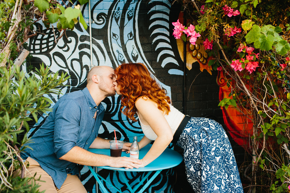 The couple kissing outside the cafe. 