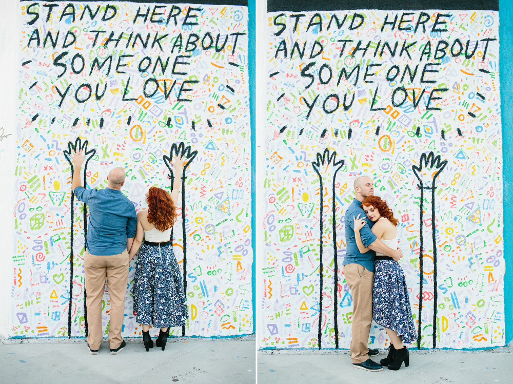 The couple in front of a cool mural. 