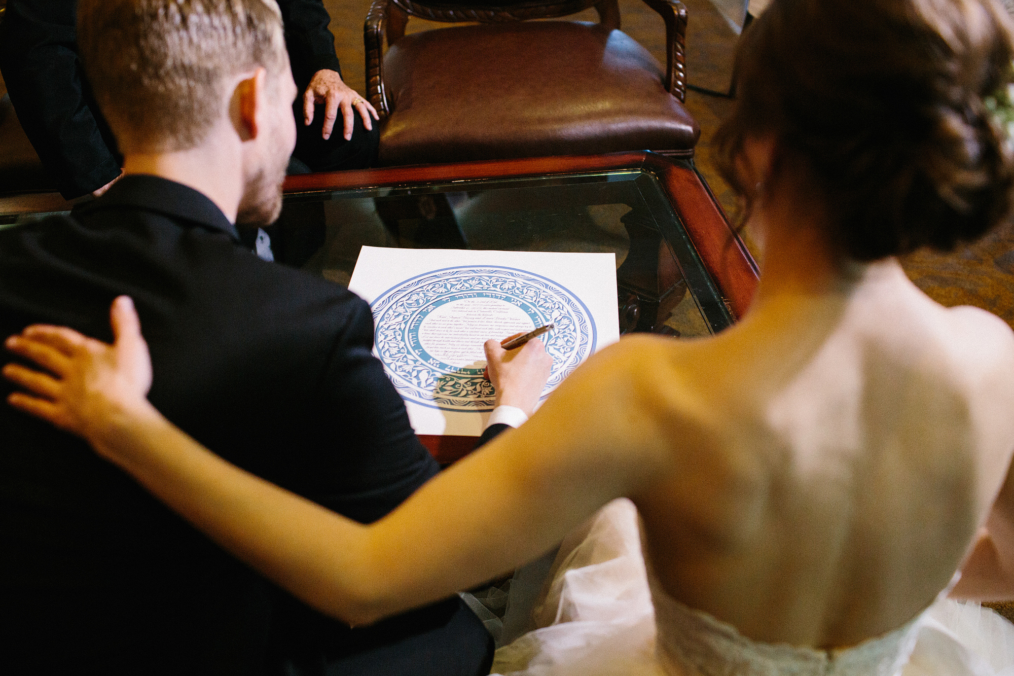 The bride and groom signing the Ketubah. 