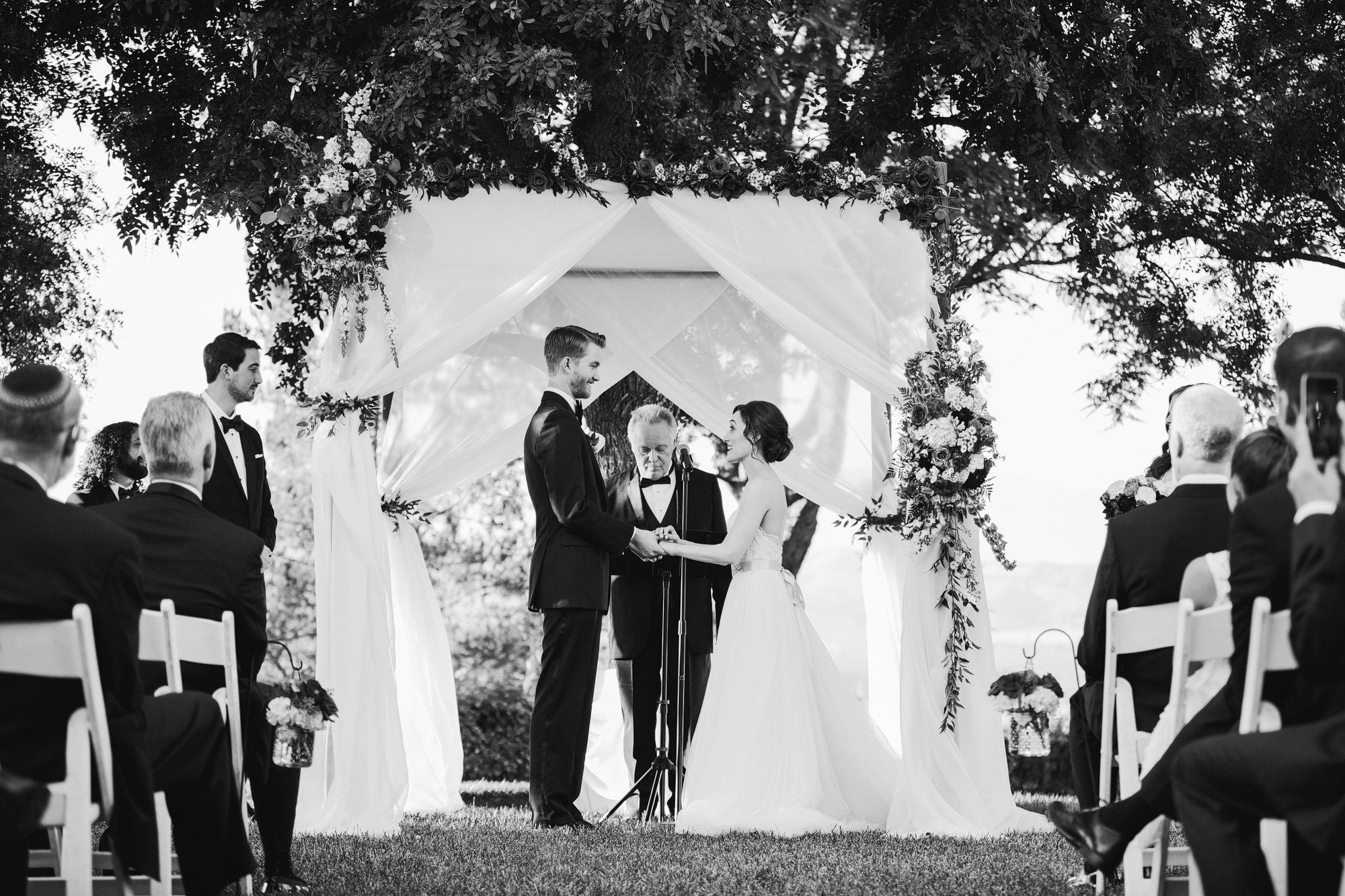 A sweet black and white photo of the couple during their wedding ceremony. 