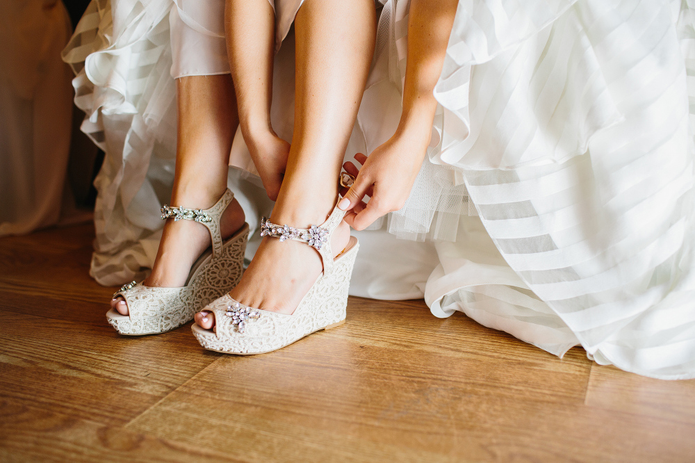 Katie putting on her wedding shoes. 