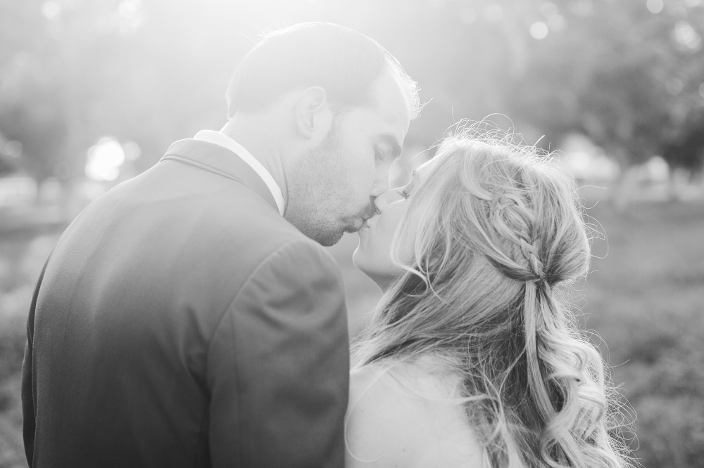 A black and white photo of Katie and Chad kissing. 