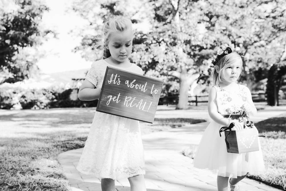 The flower girls walking down the aisle. 