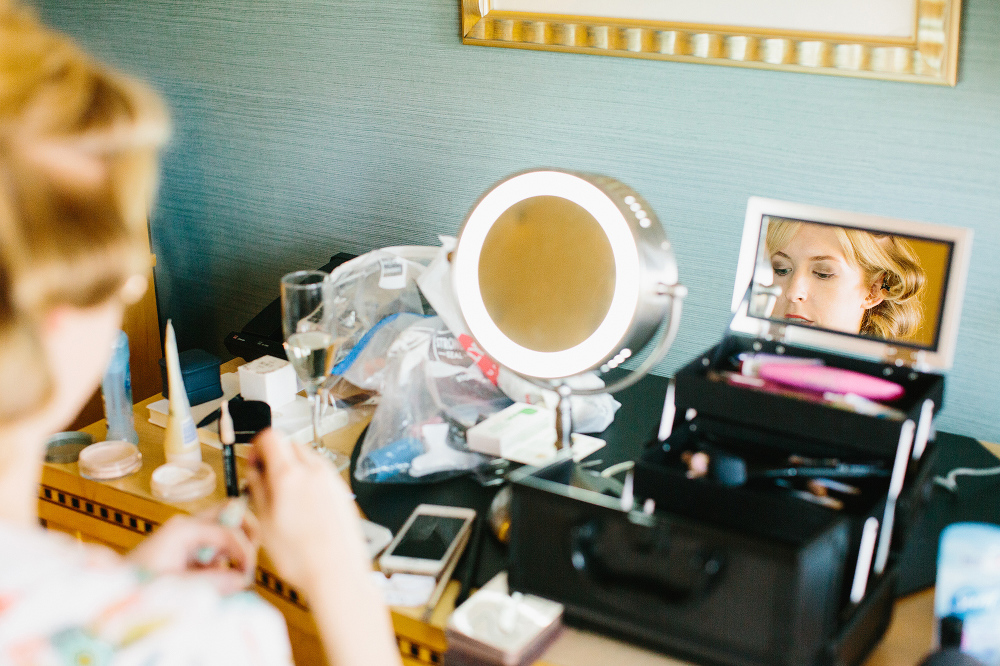 The bride doing her make-up. 