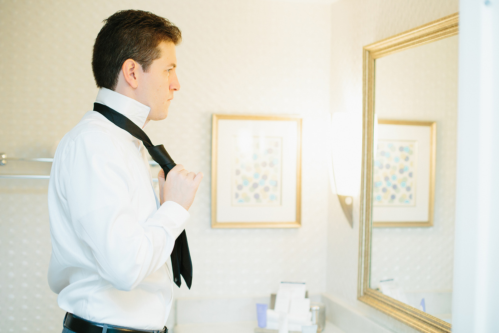 Alex putting on his tie. 