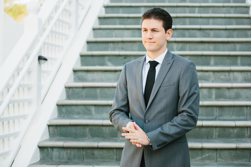 Alex in his gray suit and black tie. 