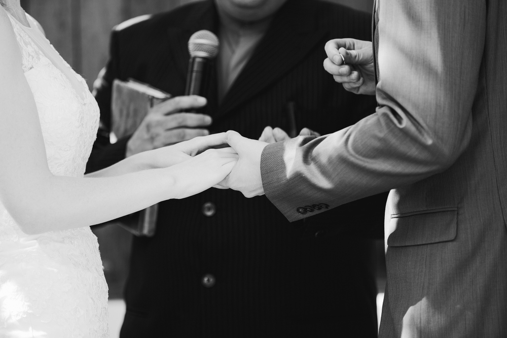 Lauren and Alex exchanging wedding rings. 