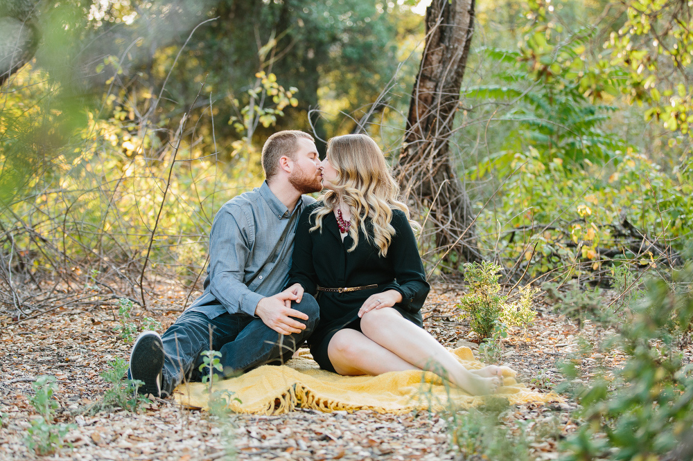 Hillary and CJ sitting on a yellow blanket. 