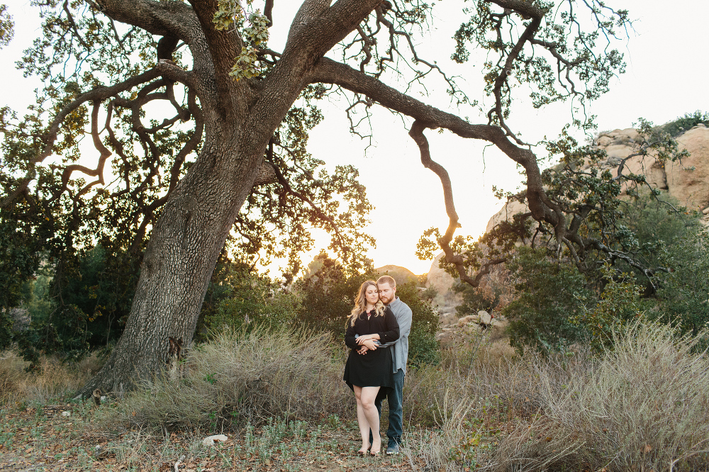 The couple under a large tree. 