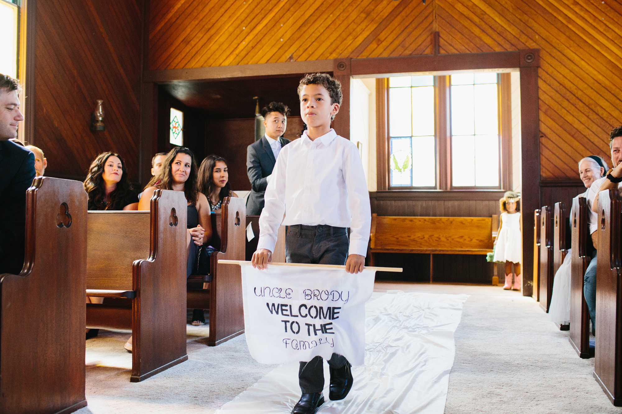 The ring bearer carried a sign down the aisle. 